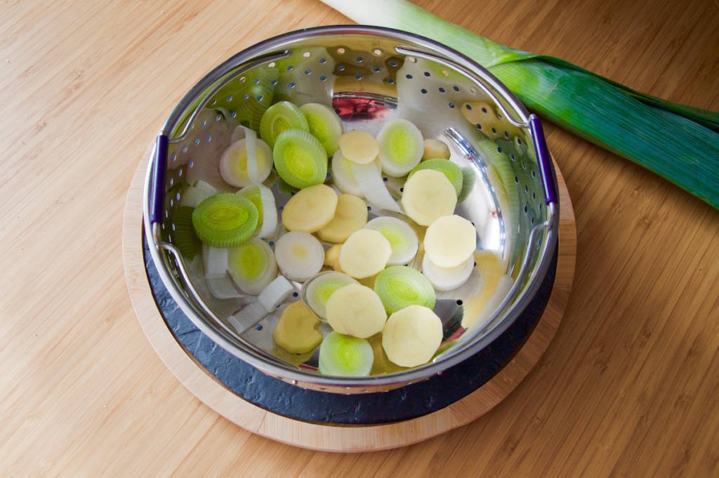 Potato and leek white slices in a steam basket for the baby puree