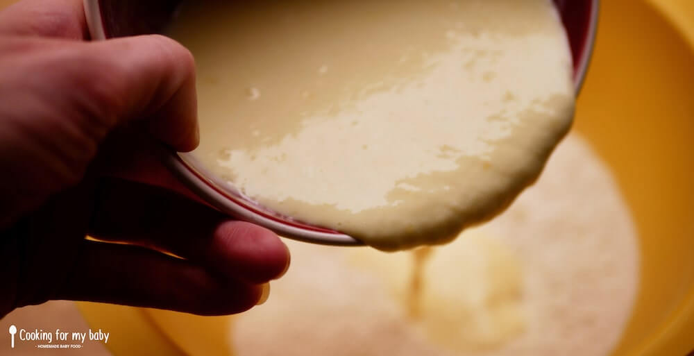 Pour liquid ingredients into dry ingredients for fluffy pancake batter