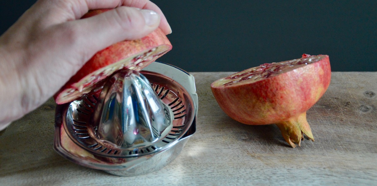 Squeezing pomegranate for baby