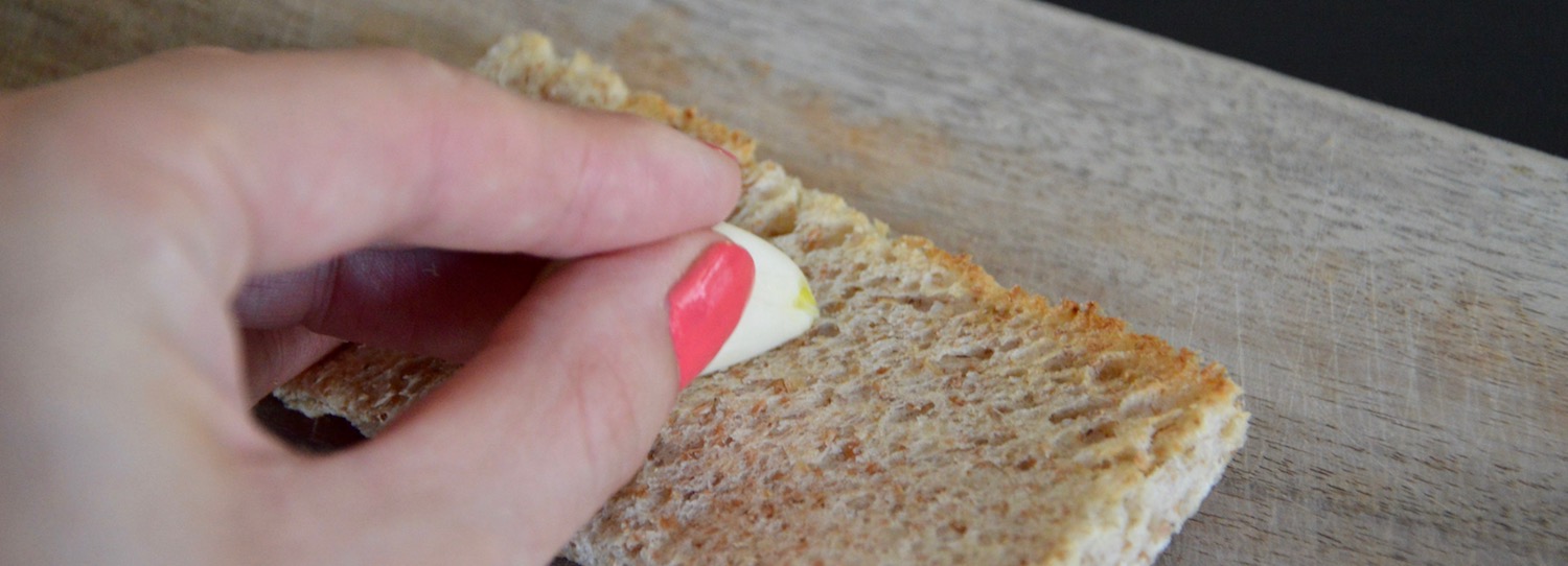 Rubbing a garlic clove on bread for baby