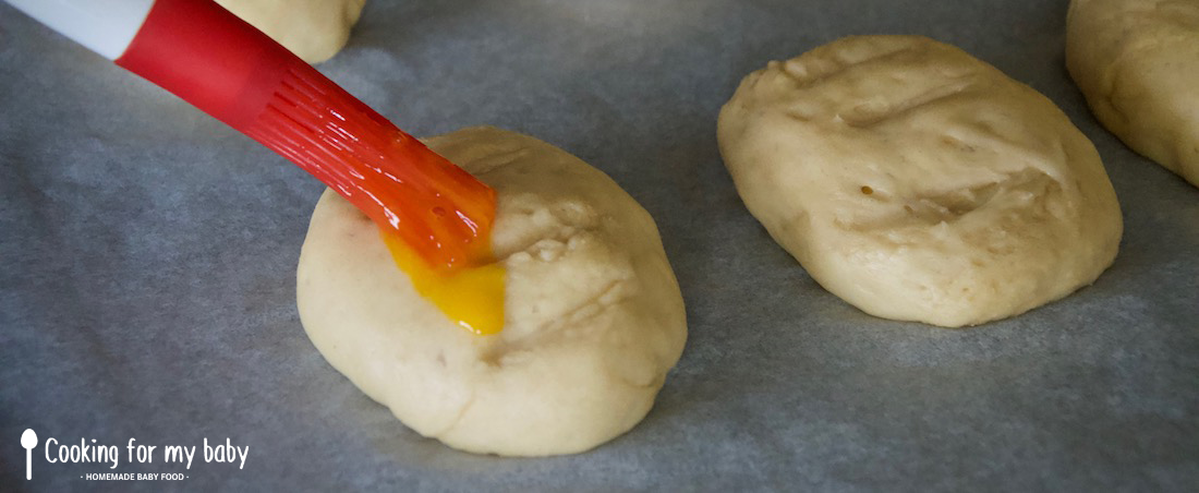 Brushing the brioche with egg yolk for baby