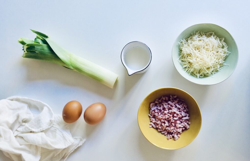 Ingredients for crustless leek, ham, and Emmental mini quiches for baby