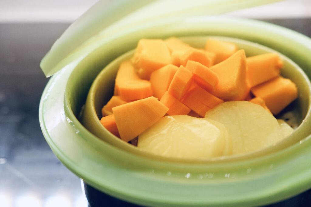 Steaming red kuri squash, carrots, and potatoes for baby soup