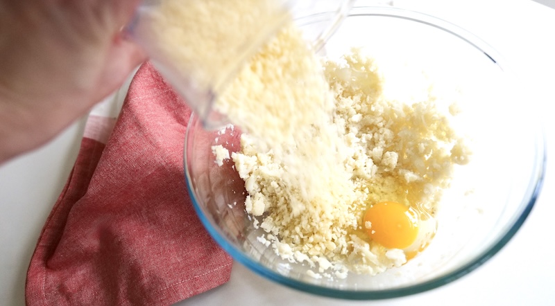 Adding grated Swiss cheese