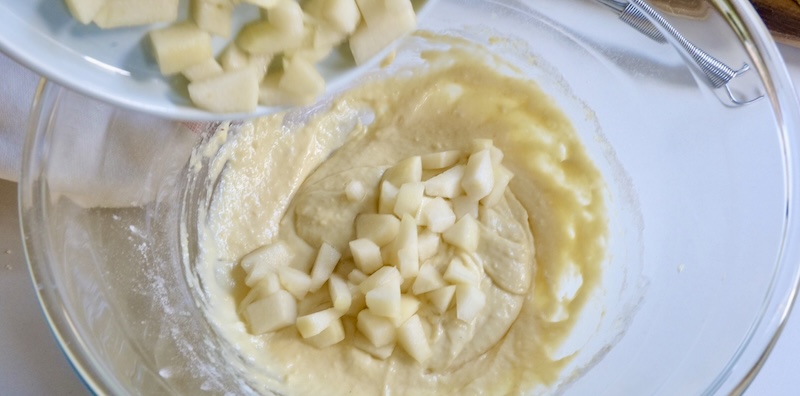 Adding pear pieces to the muffin batter