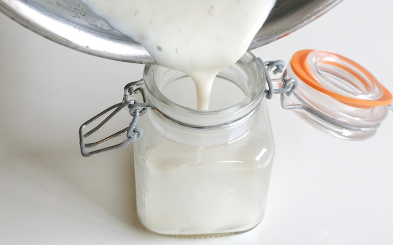 Pouring the baby vanilla cream into a small jar