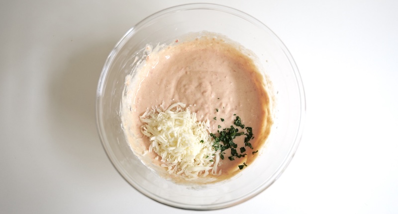 Adding mozzarella and finely chopped basil